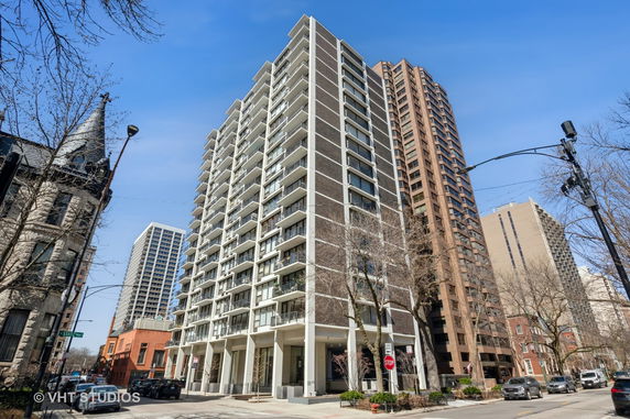 Front view of a multi-story residential building with balconies.