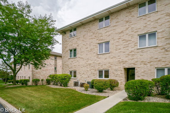 Front view of a multi-story brick apartment building.