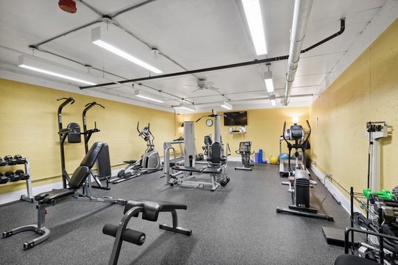 Interior view of a gym with various exercise equipment.