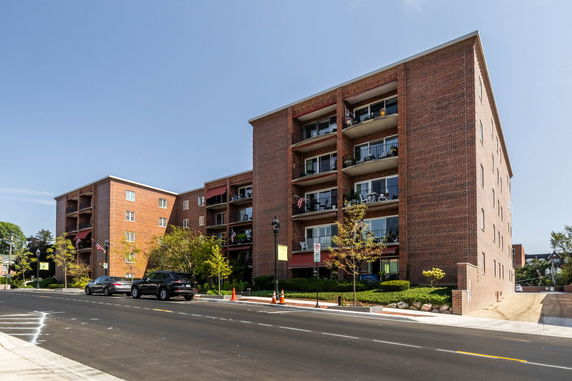 Front view of a multi-story brick apartment building.