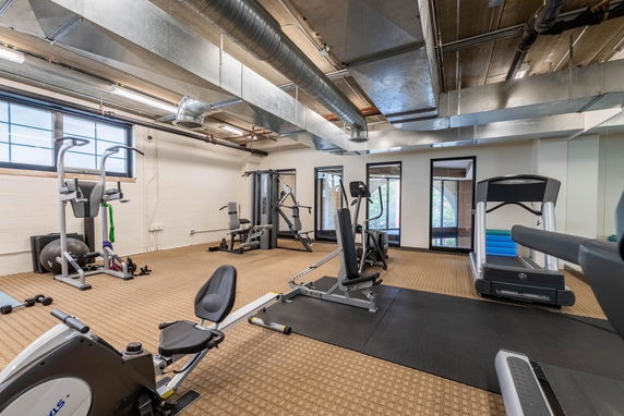 Indoor gym area with various exercise equipment.
