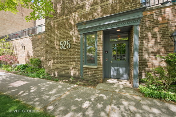 Front view of a building with a brick exterior and a door marked with the number 525.