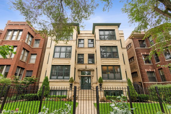 Front view of a multi-story brick apartment building.