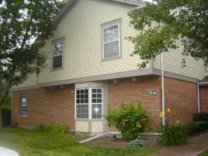 Front view of a two-story house with brick and siding exterior.