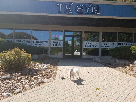 Front view of a gym building with signage for various fitness activities.