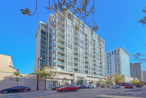 Front view of a modern high-rise building with multiple balconies.