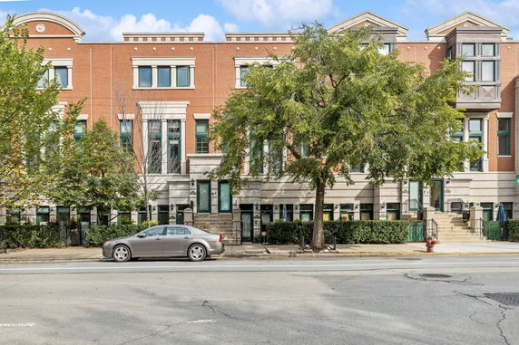 Front view of a multi-story brick building with a symmetrical design.