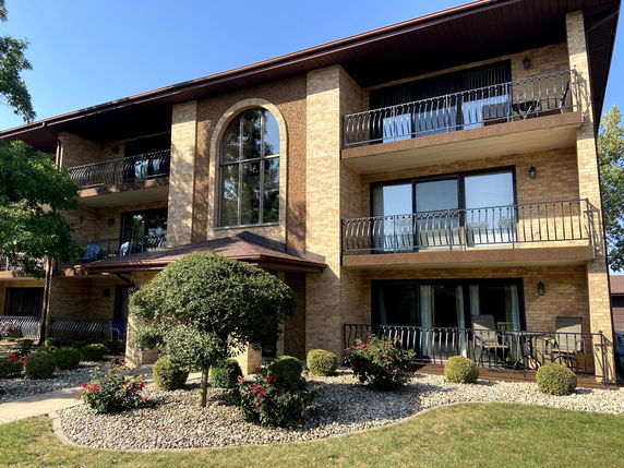 Front view of a multi-story building with balconies.
