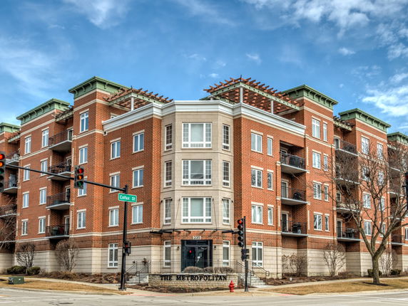 Front view of a multi-story apartment building with balconies.