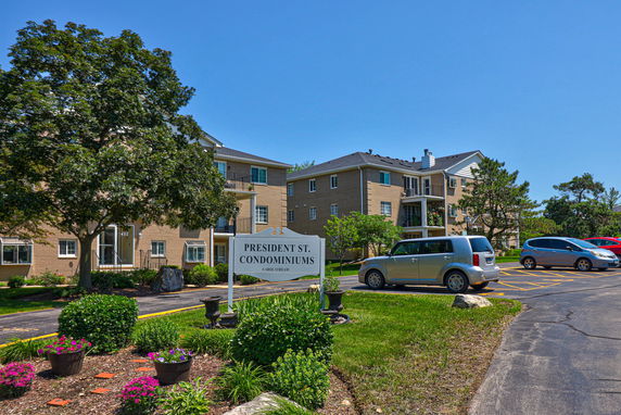 Front view of a condominium building with multiple floors.
