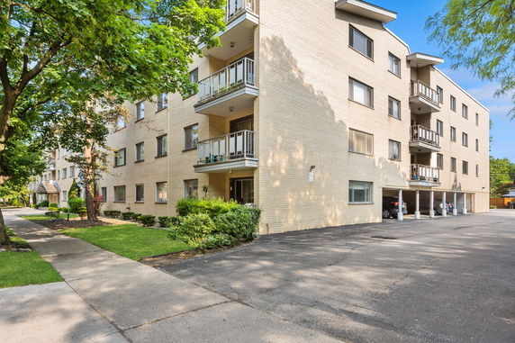 Front view of a multi-story apartment building with balconies.