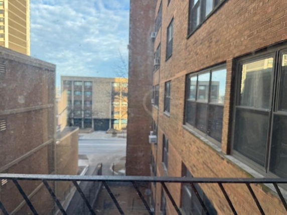 View from a window showing surrounding buildings and a street.