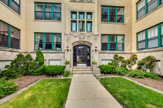 Front view of a multi-story building with decorative entrance.