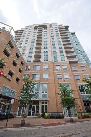 Front view of a multi-story apartment building with balconies.