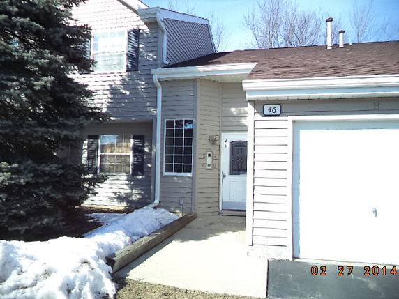 Front view of a two-story house with attached garage.