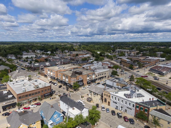 Panoramic view of a town with various buildings and streets visible.