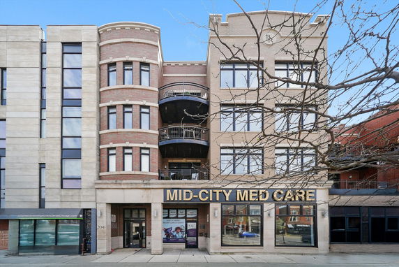Front view of a multi-story medical building with brick and stone facade.