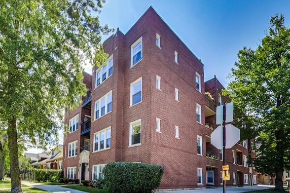 Front view of a multi-story brick apartment building.