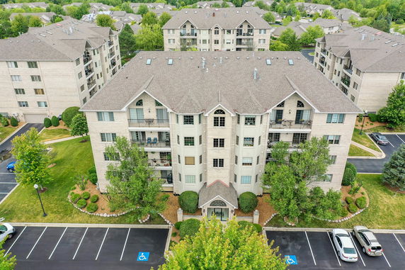Front view of a multi-story apartment building with balconies.