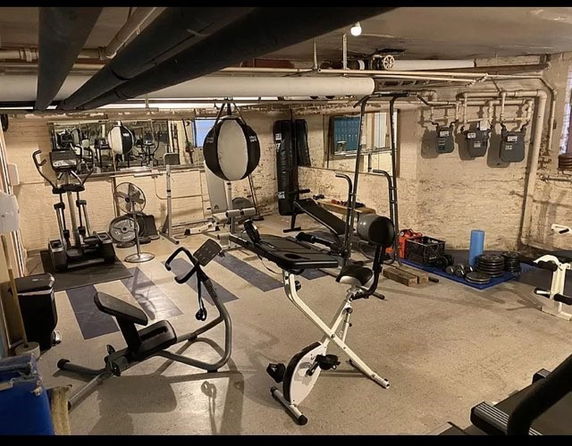 Indoor gym area with various exercise equipment.