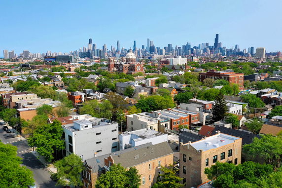 Panoramic view of a cityscape featuring residential buildings and a distant skyline.