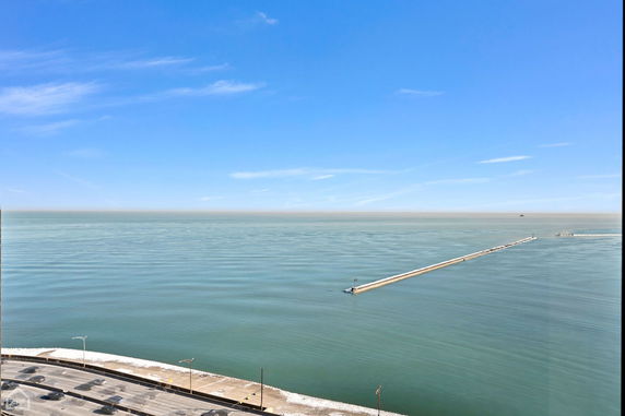 Panoramic view of a large body of water with a long pier extending into the distance.