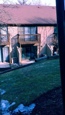 Front view of a two-story building with balconies.