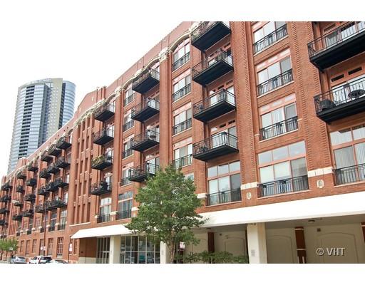 Front view of a multi-story brick building with balconies.