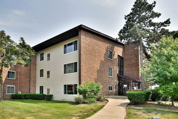 Front view of a three-story brick residential building.