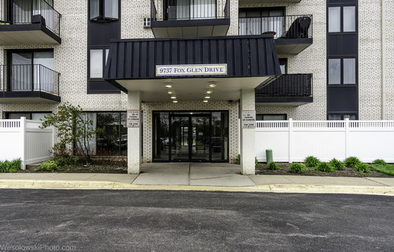 Front view of a multi-story brick building entrance.