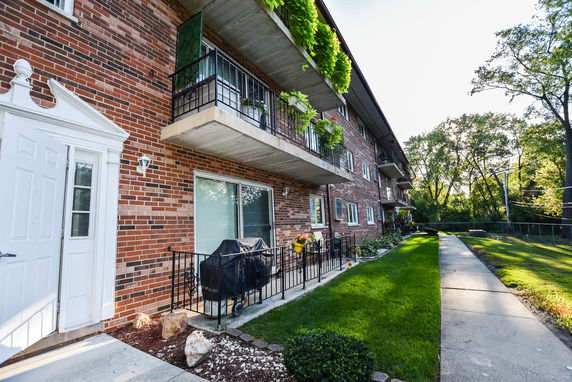 Front view of a multi-story brick building with balconies.