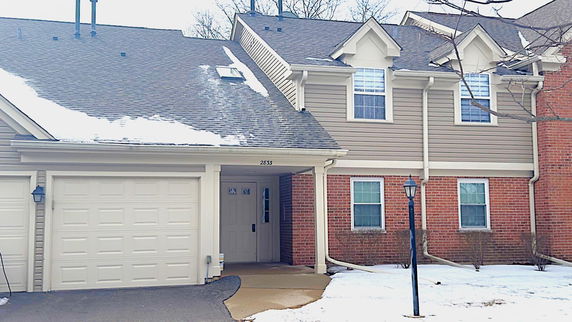 Front view of a two-story house with an attached garage.
