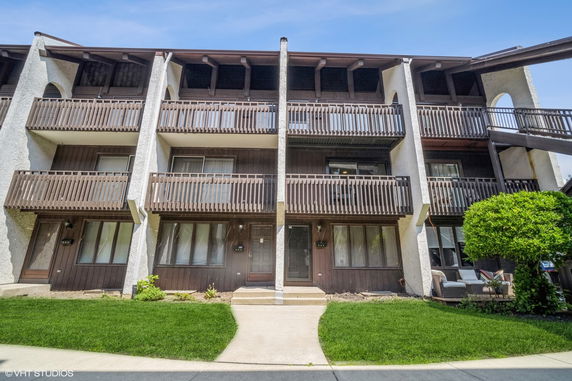 Front view of a multi-story residential building with balconies.