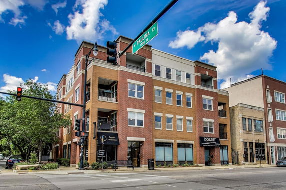 Front view of a multi-story commercial building at a street corner.