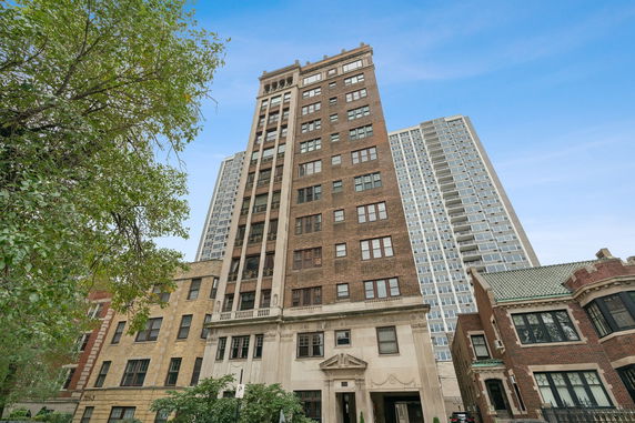 Front view of a multi-story building with brick facade.