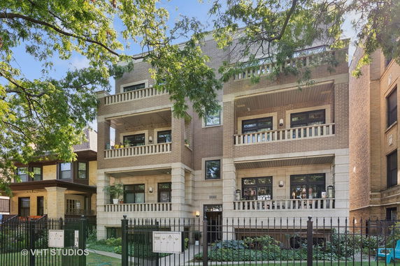 Front view of a multi-story residential building with balconies.