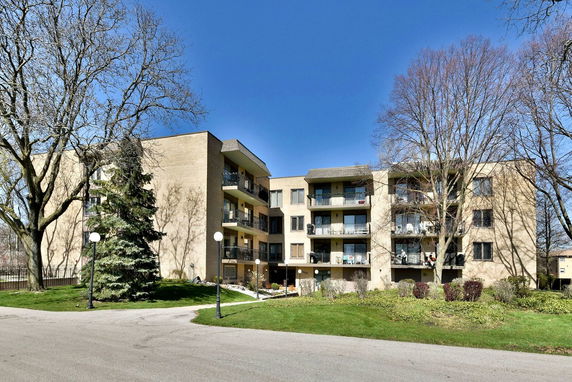 Front view of a multi-story residential building with balconies.
