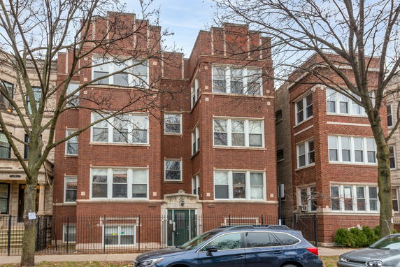 Front view of a multi-story brick apartment building.