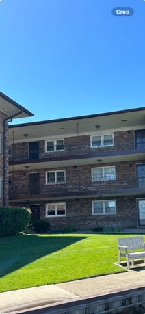 Front view of a three-story brick apartment building.