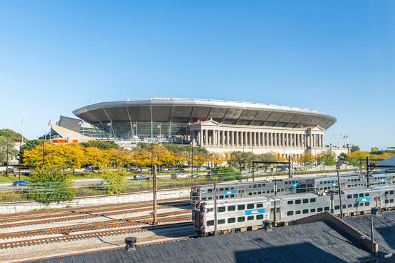 Front view of a large stadium with an architectural design featuring both modern and classical elements.