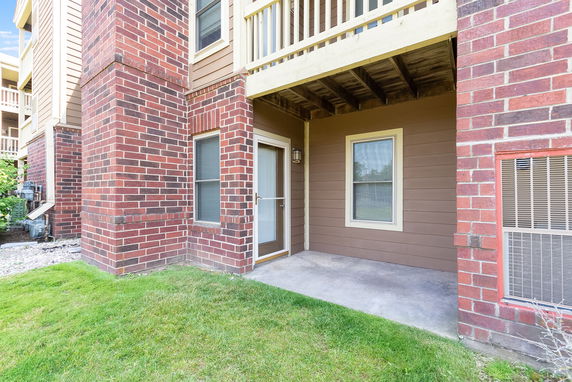 Front view of a building with brown and red brick exterior walls and a small porch area.