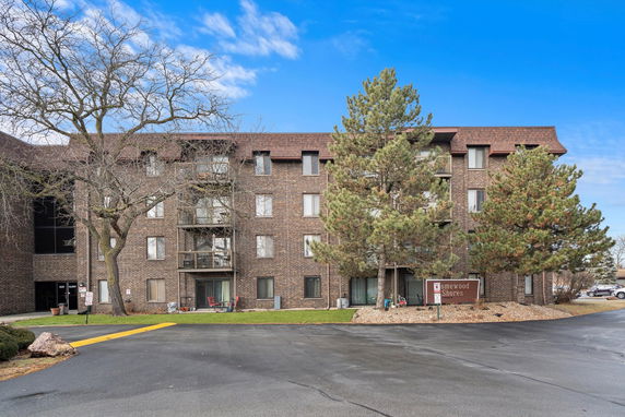 Front view of a multi-story brick apartment building.