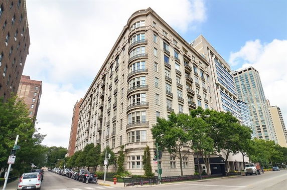 Street view of a multi-story residential building with ornate facade.