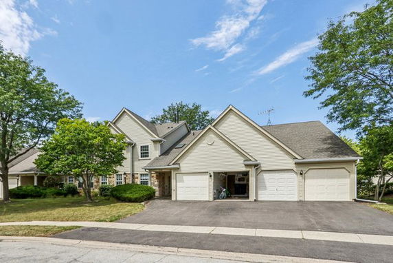 Front view of a two-story house with a three-car garage.