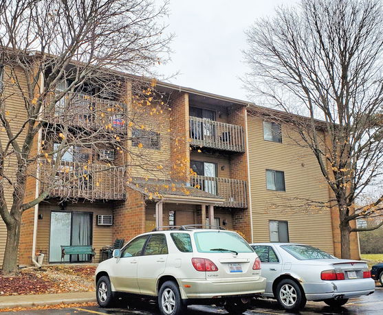 Front view of a multi-story apartment building with balconies.