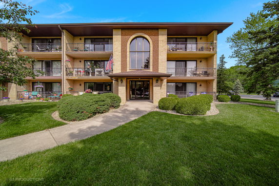 Front view of a multi-story residential building with balconies.
