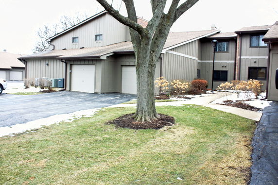 Front view of a multi-story house with attached garage.