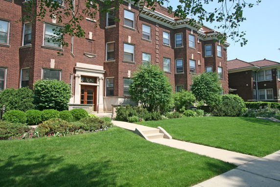Front view of a multi-story brick apartment building.