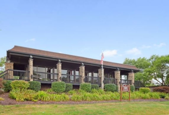 Front view of a building with prominent pillars and a porch.