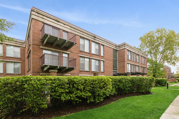 Front view of a two-story brick building with balconies.
